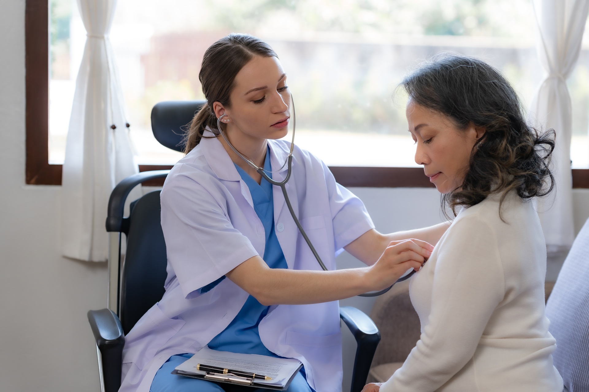 Female doctor is using a stethoscope to measure the heart rate at work place